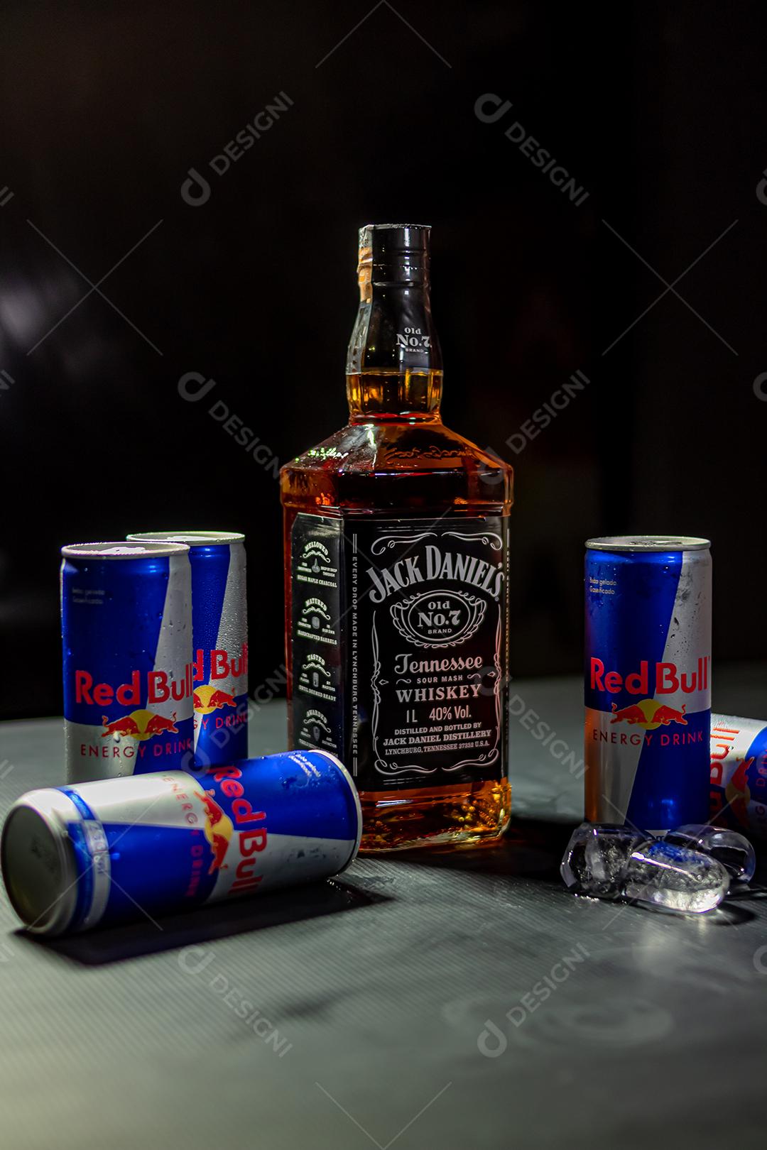 Garrafa de Uísque Jack Daniels com energetico red Bul bebida sobre fundo preto
