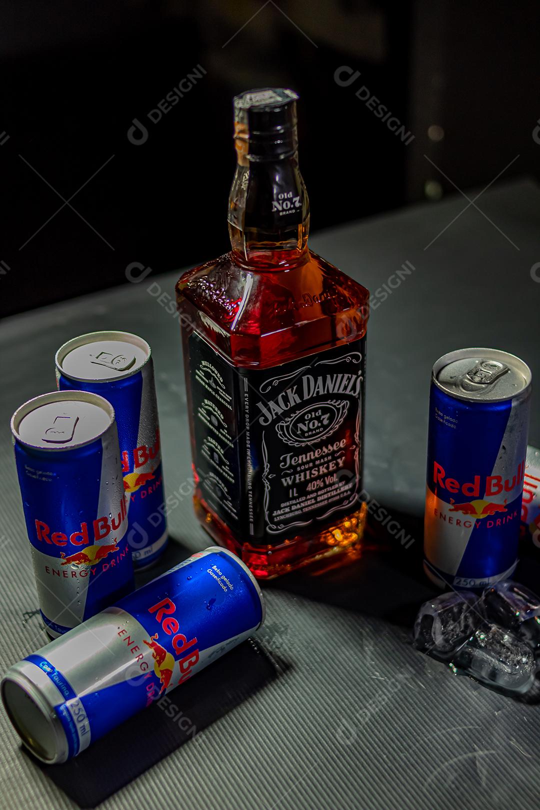 Garrafa de Uísque Jack Daniels com energetico red Bul bebida sobre fundo preto