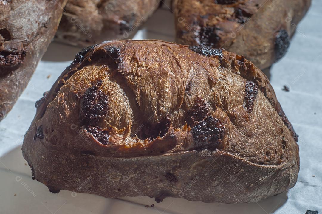 Chocolate french bread, cocoa bread baked with orange zest and placed together on a shelf.