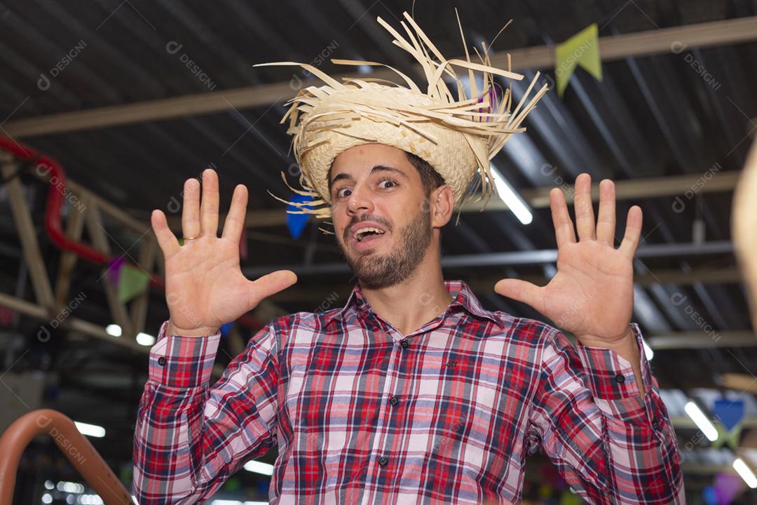 Homem bonito com roupas típicas da festa junina sorrindo