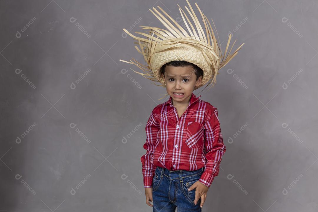 menino bonitinho vestindo roupas típicas para Festa Junina