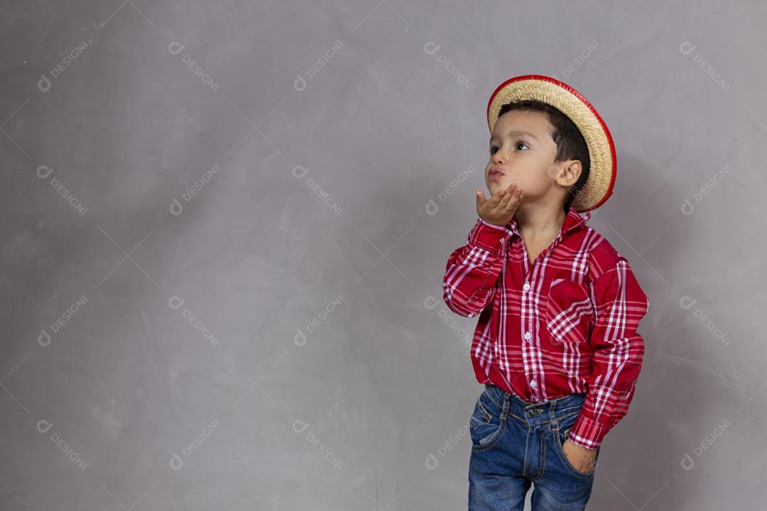 menino bonitinho vestindo roupas típicas para Festa Junina