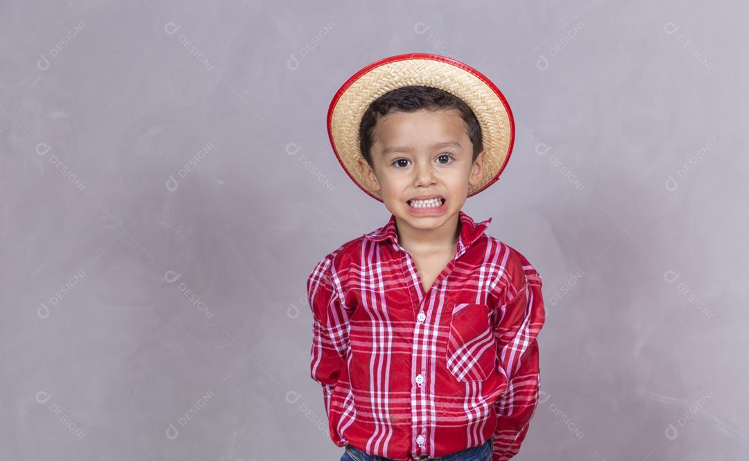menino bonitinho vestindo roupas típicas para Festa Junina