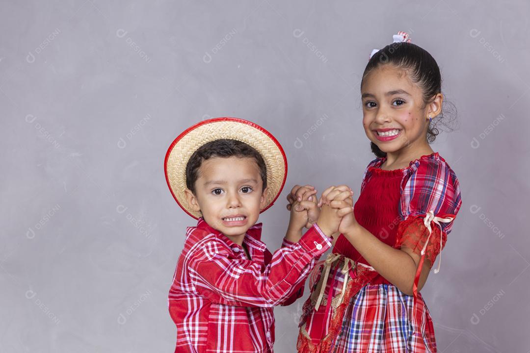 casal de irmãos vestindo roupas tradicionais para a Festa Junina