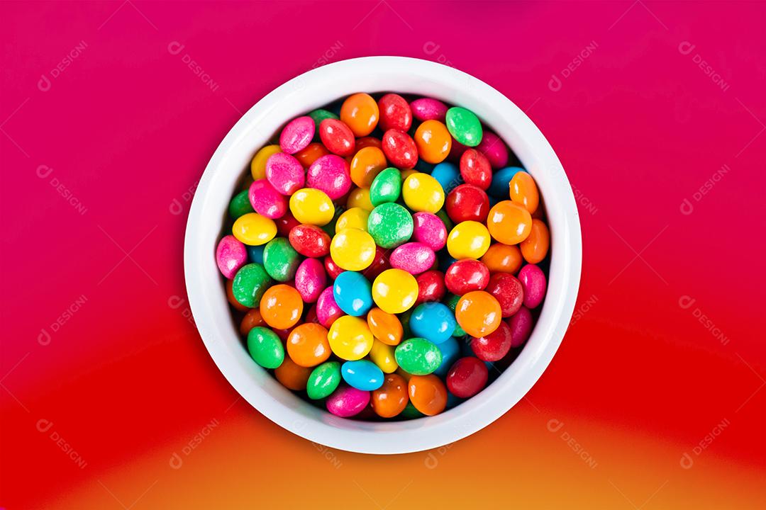 Confete colorido doce na vista superior da tigela branca