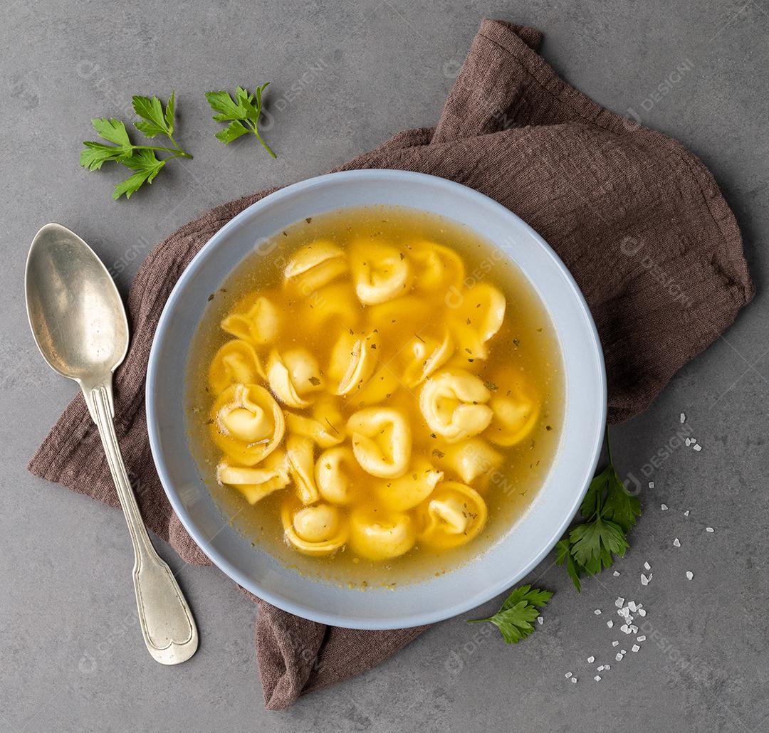 Sopa de cappelletti ou tortellini brodo em uma tigela com tempero ov