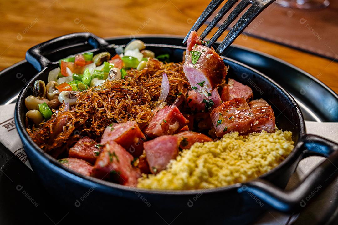 Panela de comida com cuscuz carne desfiada linguicinha e legumes