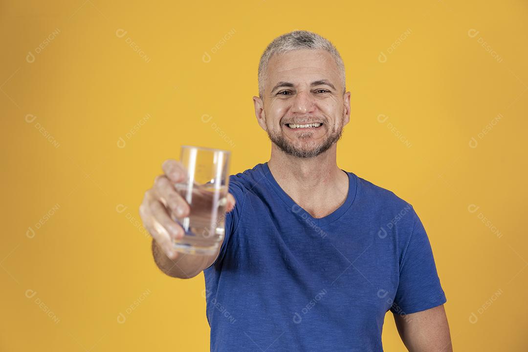 Homem de meia idade segurando copo de água