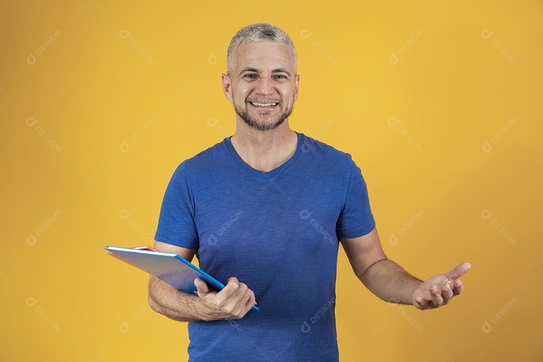 Homem de meia idade estudando com cadernos na mão