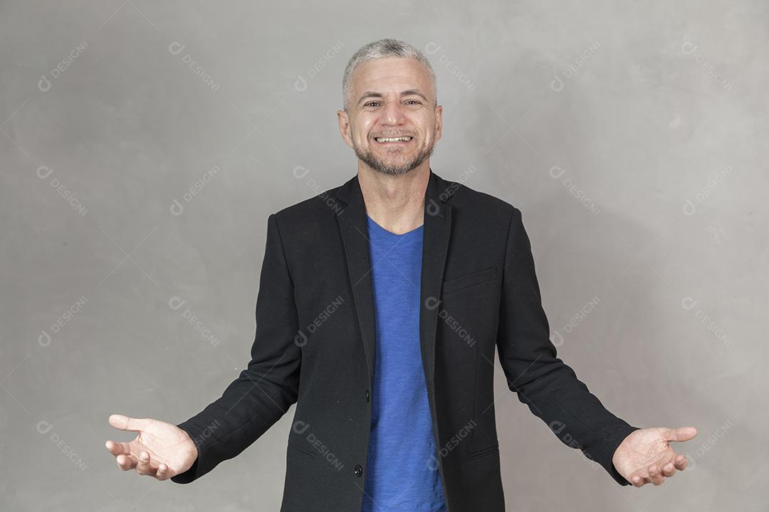 Homem de meia idade sorrindo com braços aberto