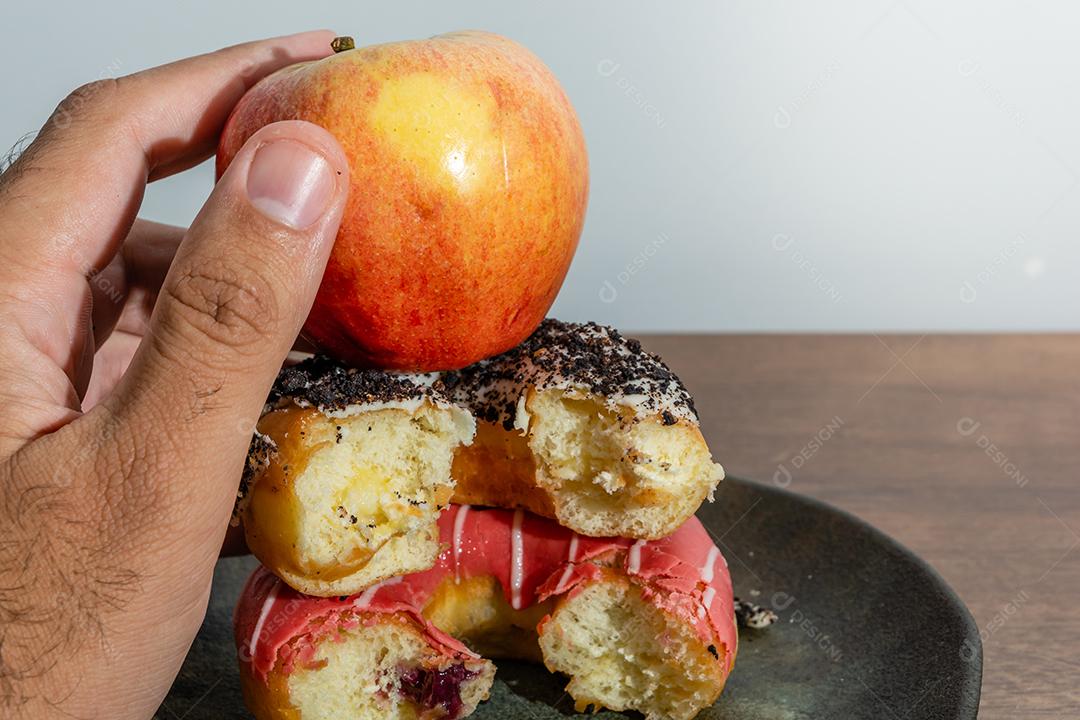 Bolinhos donuts everglazed com maçã sobre mesa madeira fundo branco