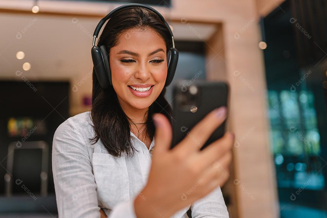 Linda garota latina usando seu celular.