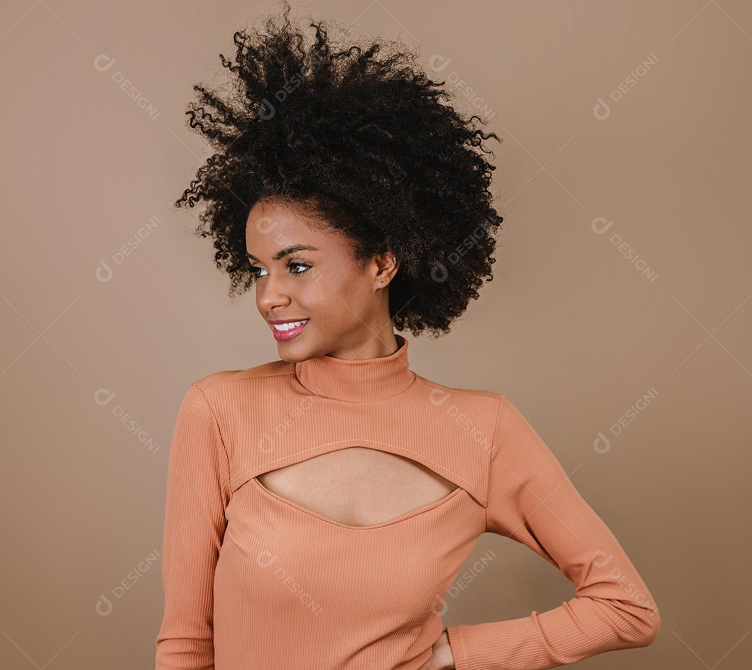 Mulher latina de beleza com penteado afro. mulher brasileira. Segurando a embalagem de xampu em branco