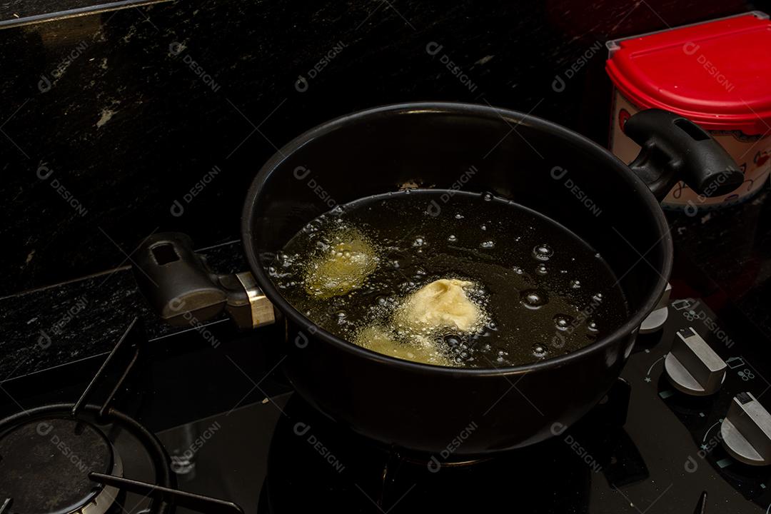 frying the dough in cold oil, testing the temperature of the oil