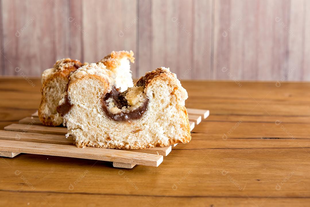 pieces of traditional Brazilian Cuca filled with chocolate on wooden table