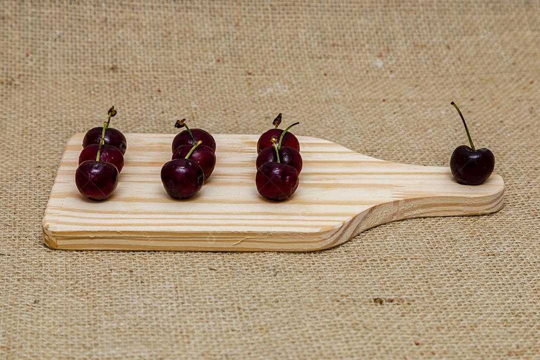 Fruta comida cereja sobre tabua de madeira
