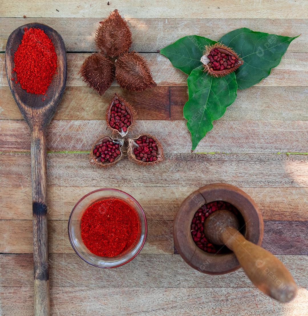 Urucum sobre uma mesa pilão colher de pau