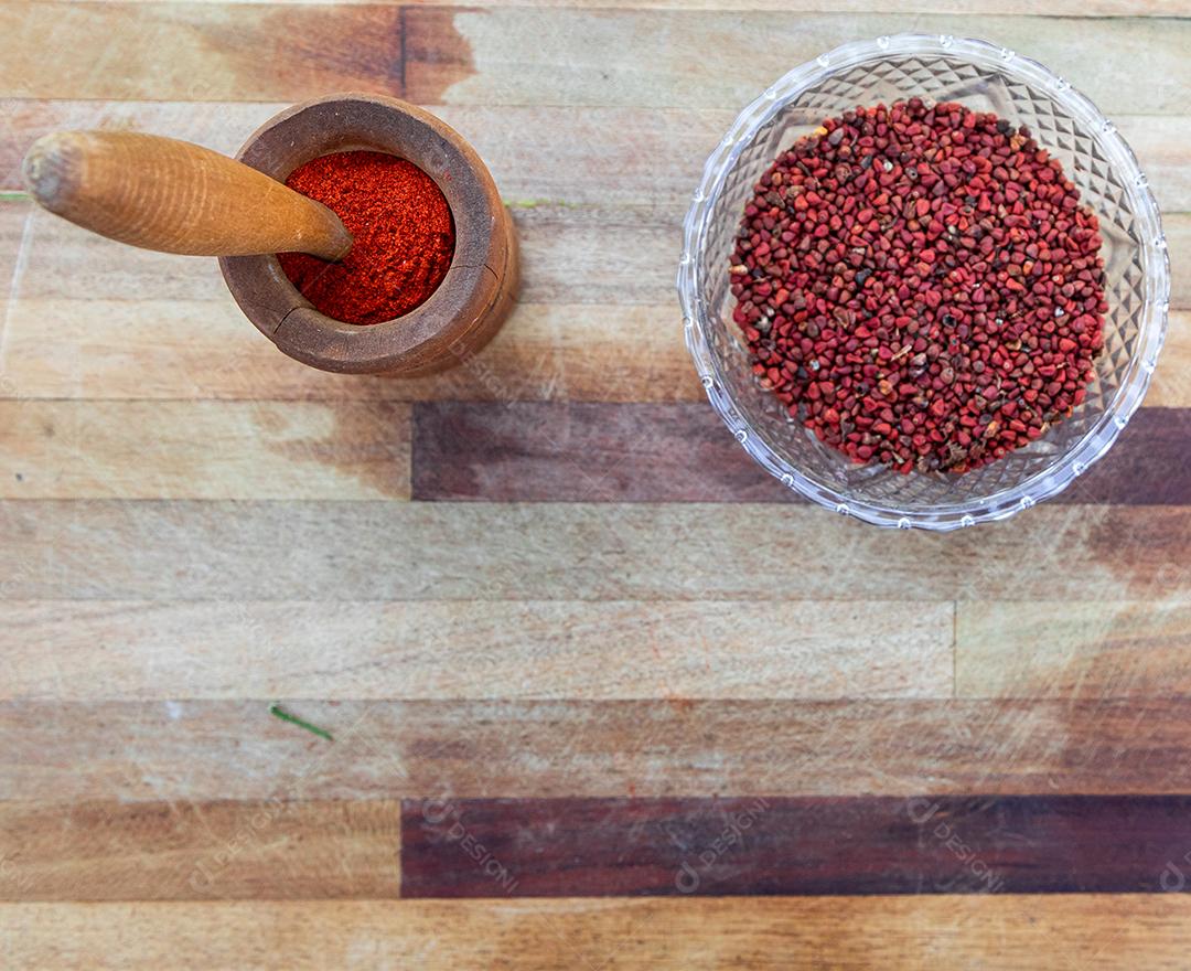 Urucum on a table pestle wooden spoon