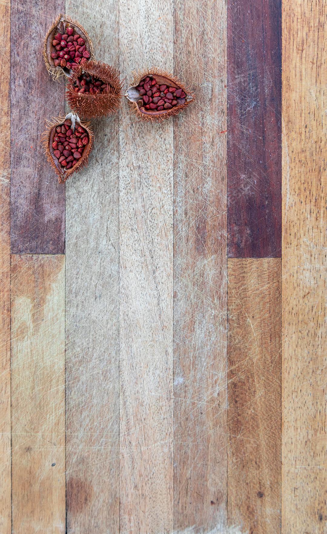 Urucum sobre uma mesa pilão colher de pau