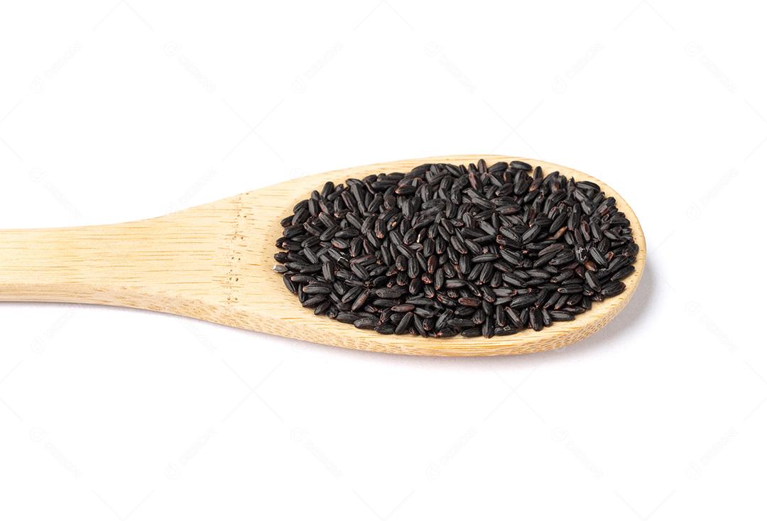 Arroz preto cru em uma colher isolada sobre fundo branco