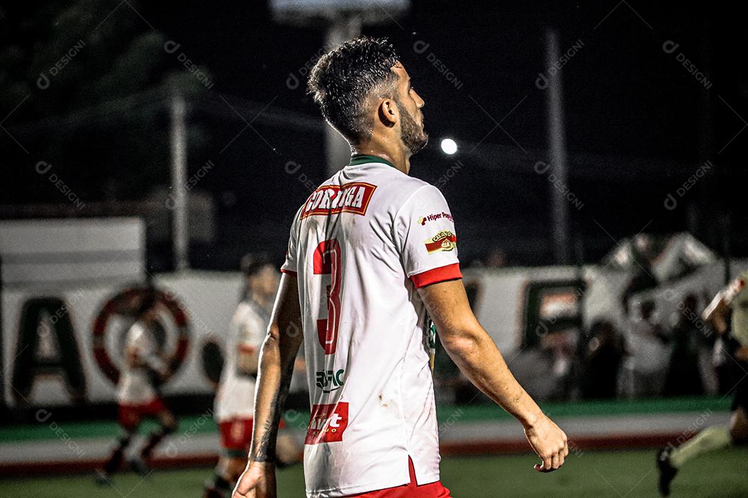 Homem jogador de futebol chutando bola