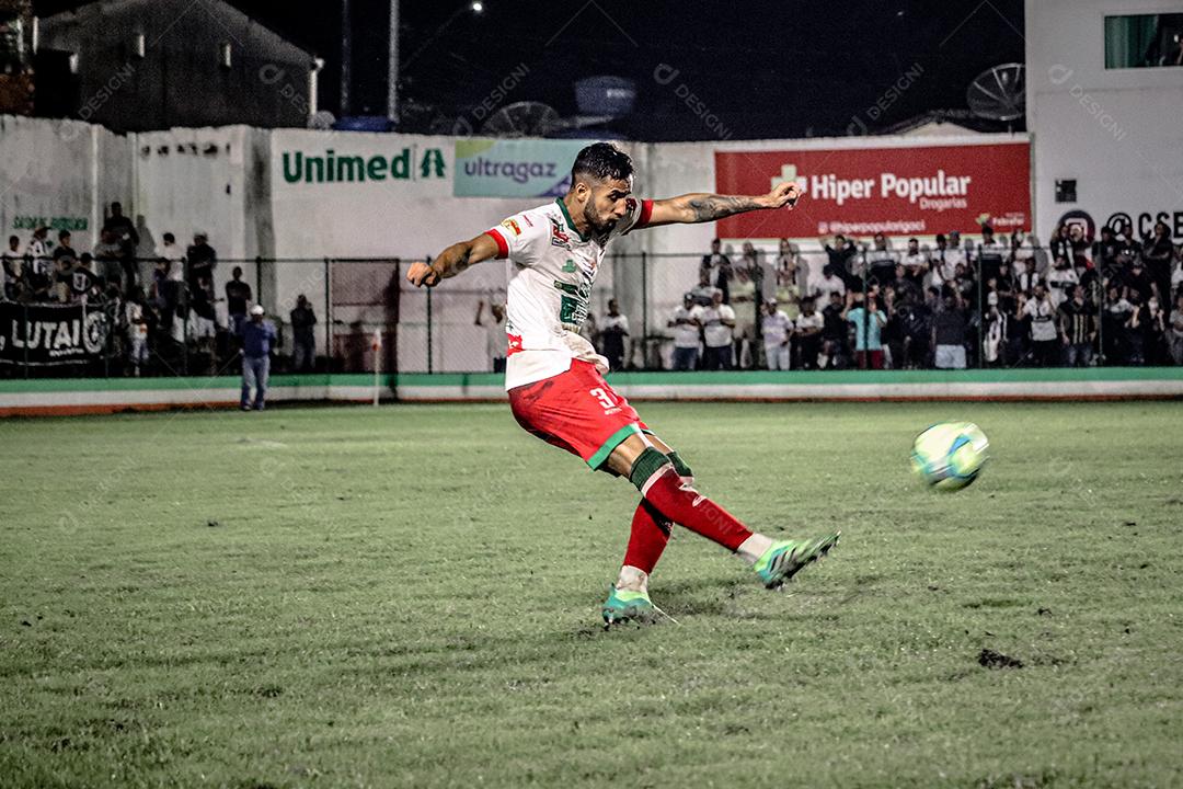 Homem jogador de futebol chutando bola