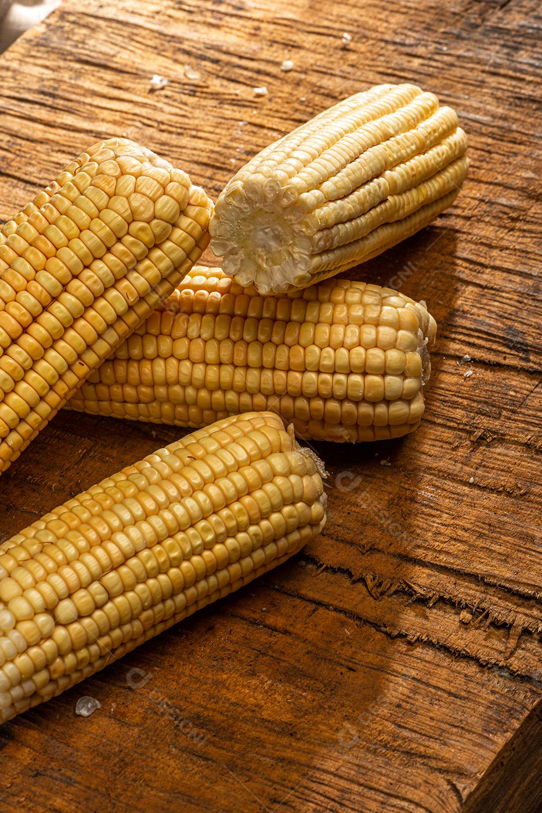 Espiga de milho em fundo de madeira rústica.
