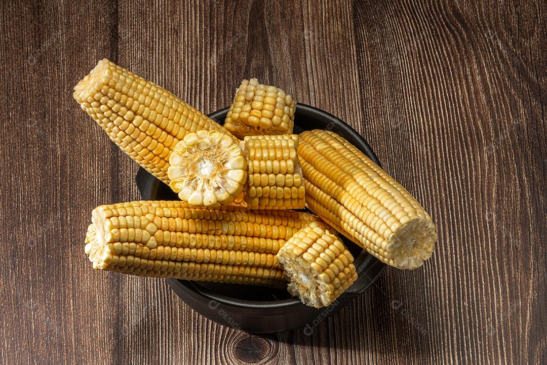 Espiga de milho em fundo de madeira rústica.