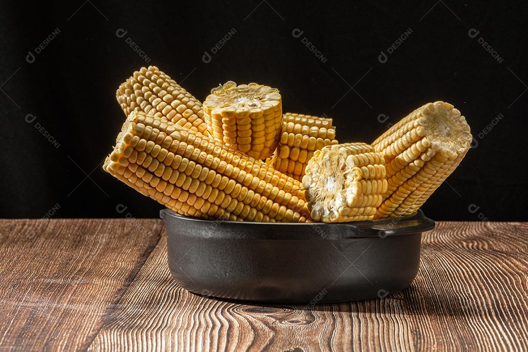 Espiga de milho em fundo de madeira rústica.