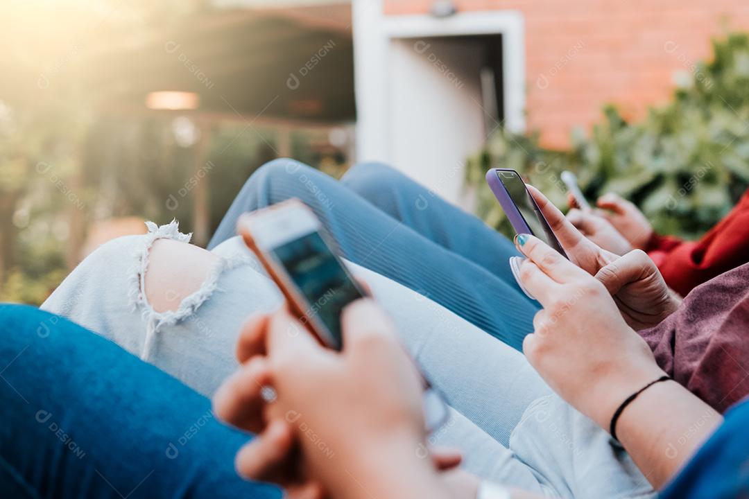 Grupo de amigos multirraciais usando smartphones para compartilhar conteúdo nas redes sociais