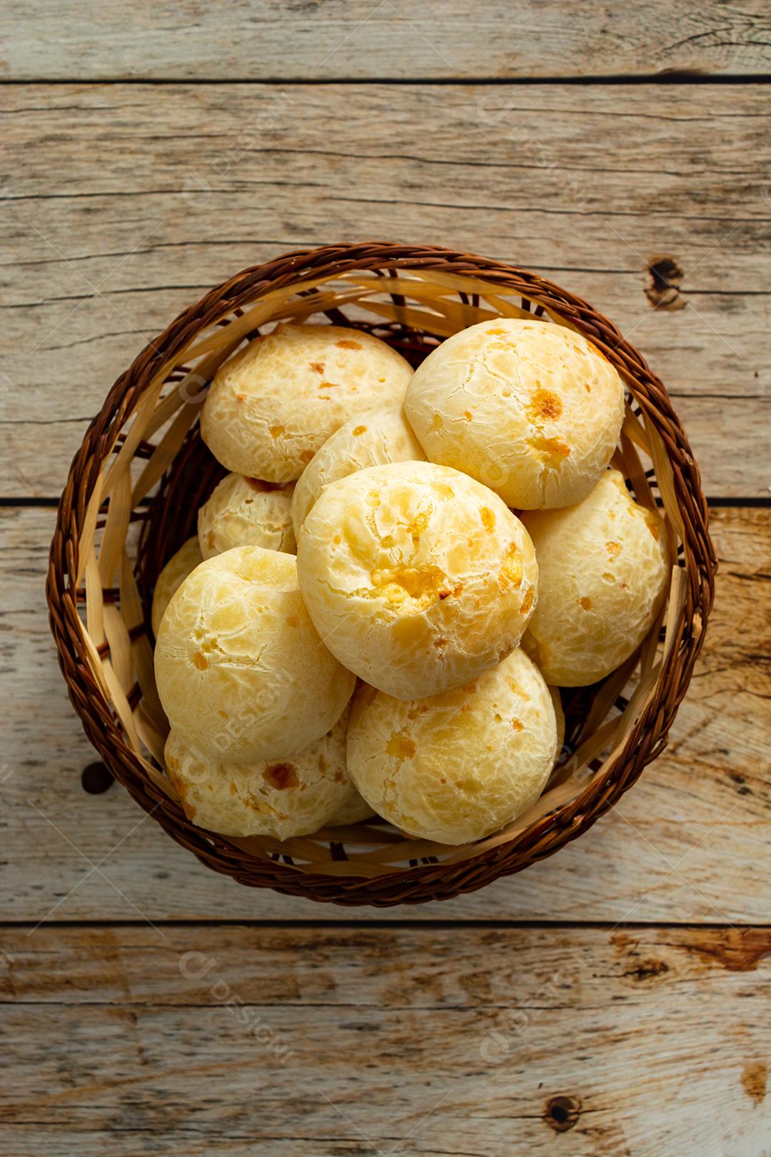 pao de queijo e café sobre uma mesa de madeira