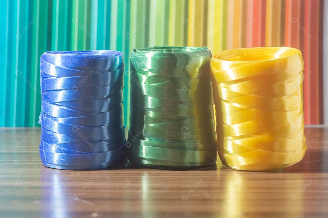 Fitas coloridas com cores amarelo e azul verde com fundo colorido, conceito de cores da bandeira do brasil em uma mesa de madeira.