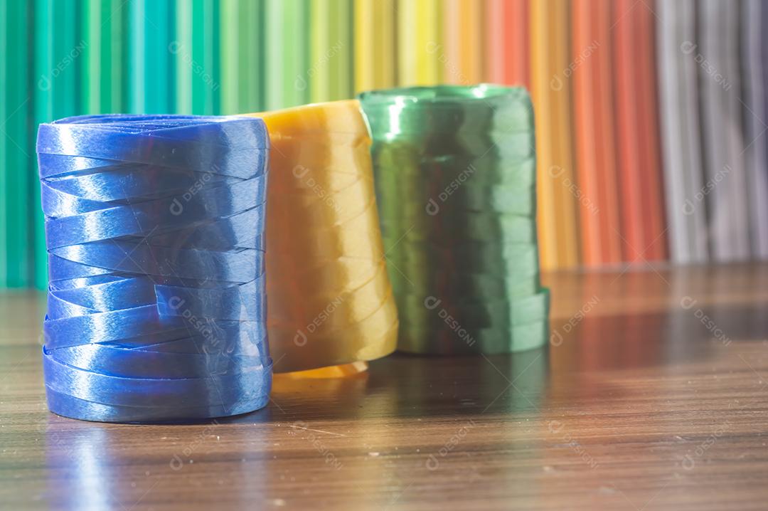 Fitas coloridas com cores amarelo e azul verde com fundo colorido, conceito de cores da bandeira do brasil em uma mesa de madeira.