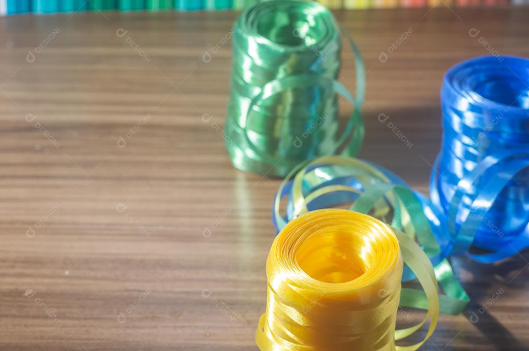 Fitas coloridas com cores amarelo e azul verde com fundo colorido, conceito de cores da bandeira do brasil em uma mesa de madeira.