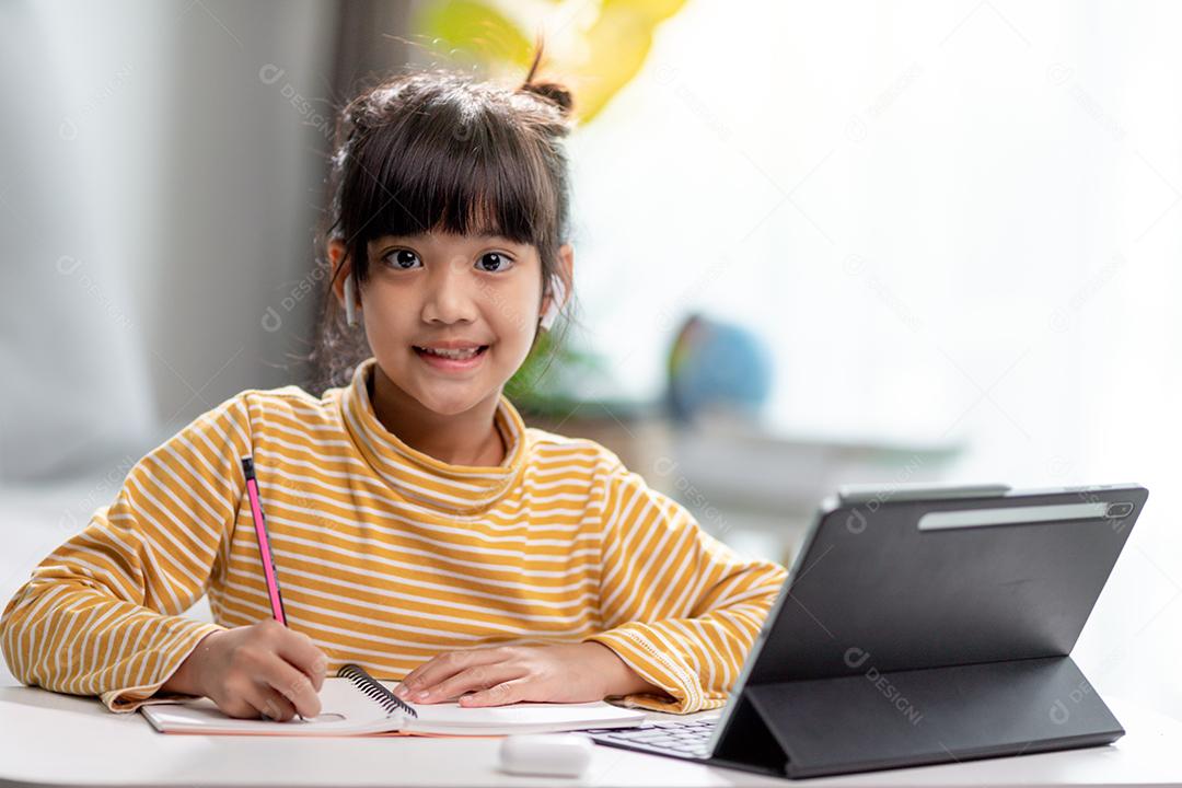 Auto-isolamento infantil usando tablet para sua lição de casa, Criança usando tablet digital pesquisando informações na internet durante o bloqueio covid 19, Educação em casa, Distância social, E-learning educação on-line