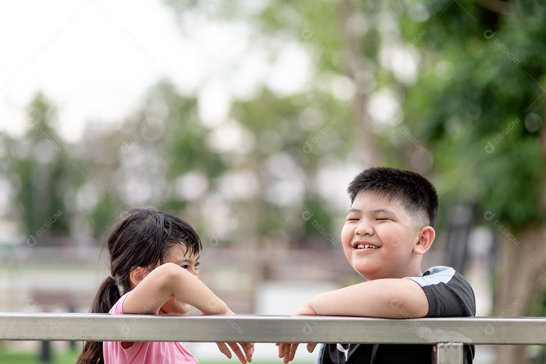 two asian children boy and girl happy and smile in the park