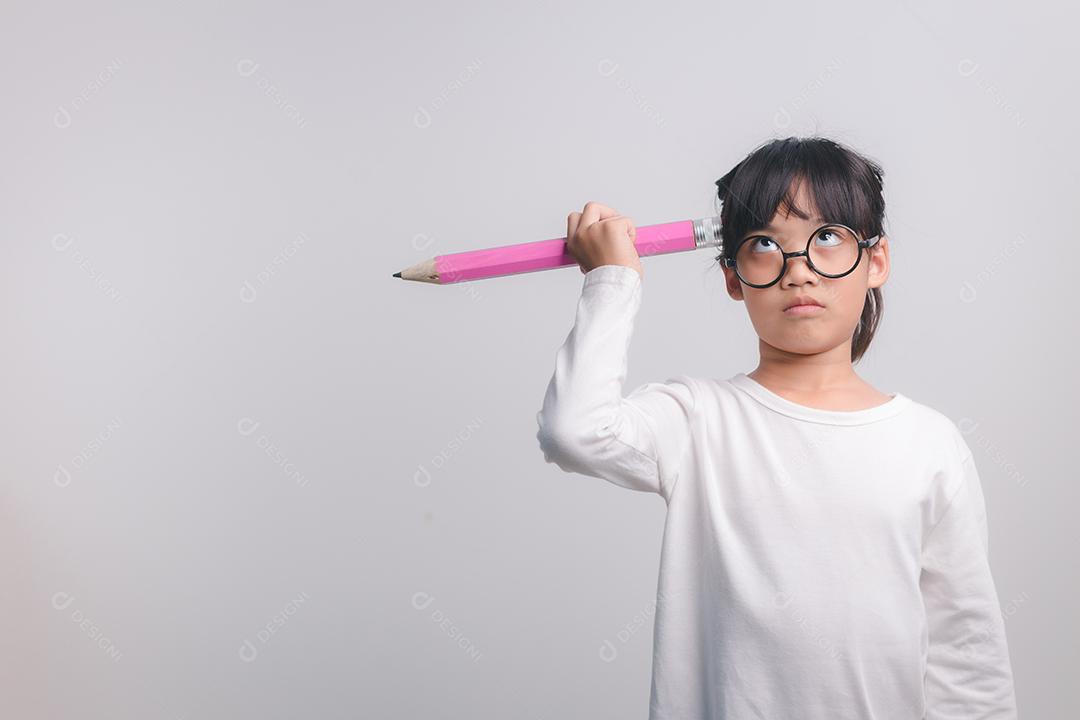 Young excited girl holding big pencils in her hands. Back to school.