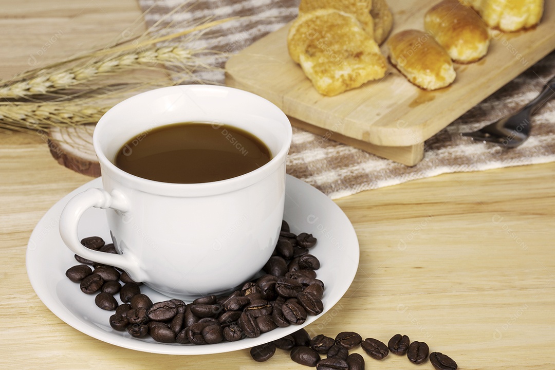 Xícara de café com grãos de café na mesa de madeira.