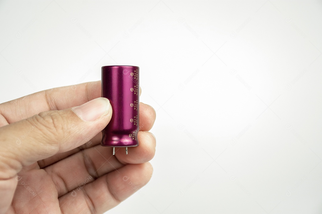 Fechar o capacitor eletrolítico na mão com um fundo de cor branca