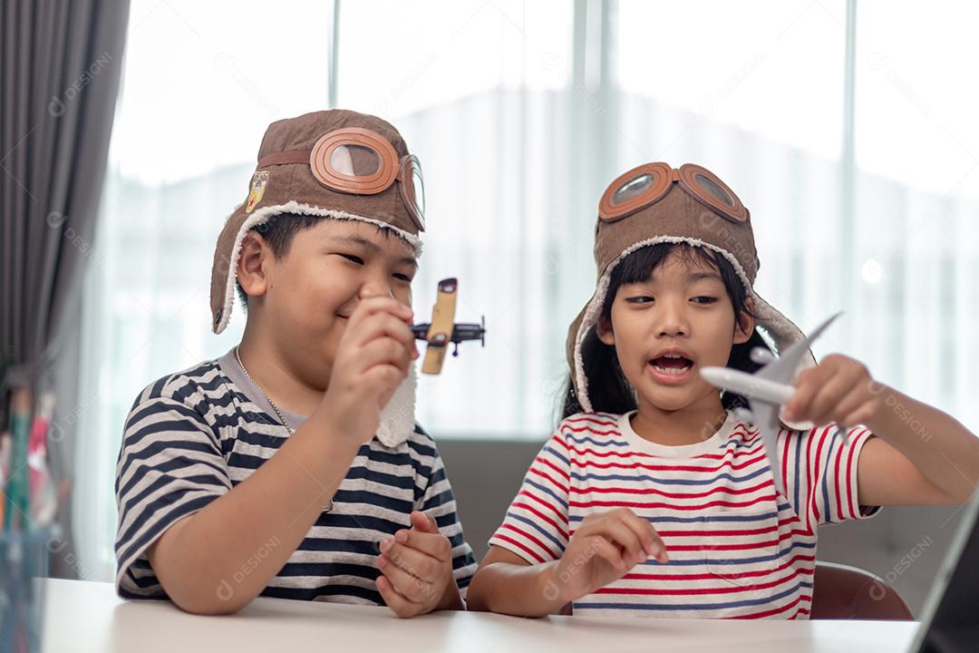 Duas crianças com aviões nas mãos