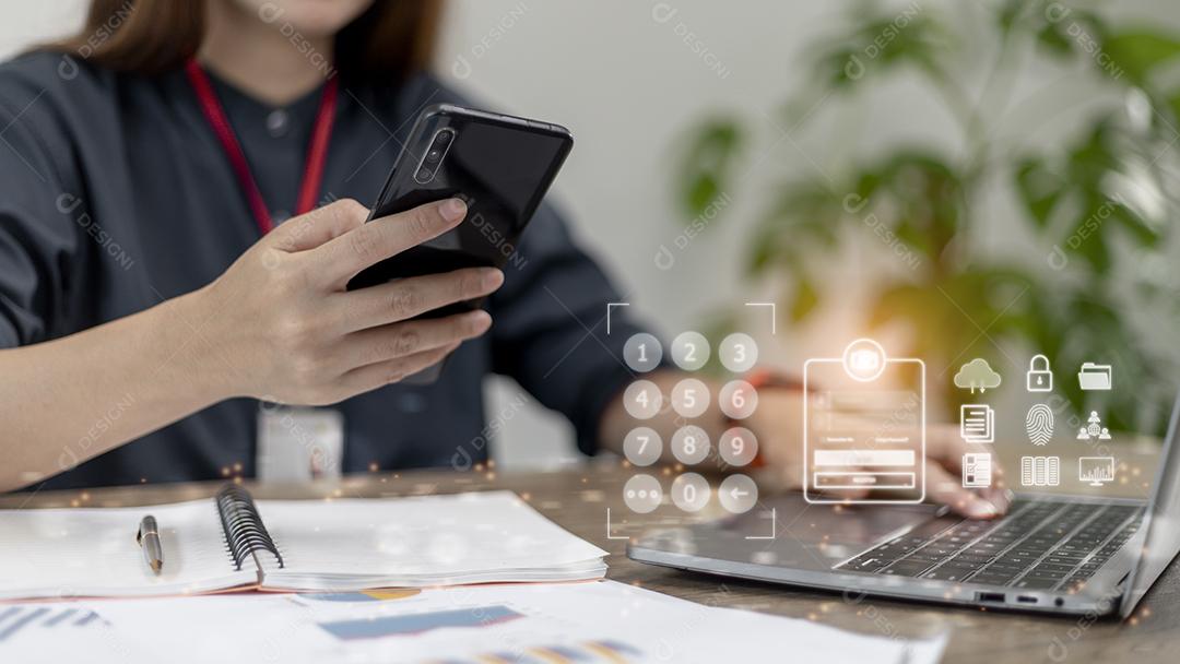 Conceito de negócios, tecnologia, internet e redes. Jovem empresária trabalhando em seu laptop no escritório, selecione o ícone de segurança no visor virtual.