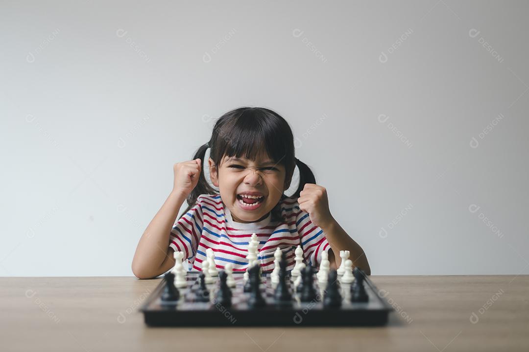 Asian girl playing chess at home. a game of chess