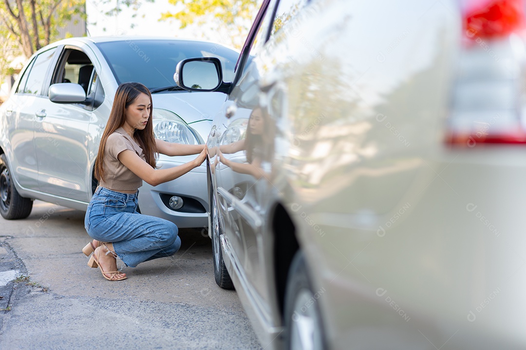 Mulher vendo situação do seu automóvel depois de acidente