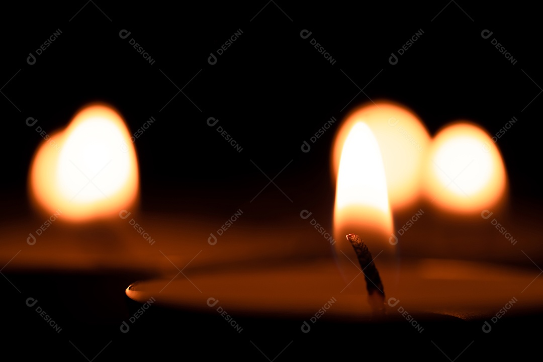 Cup candles that are lit in the dark, holy light, burning candles on the dark surface. Memorial Day