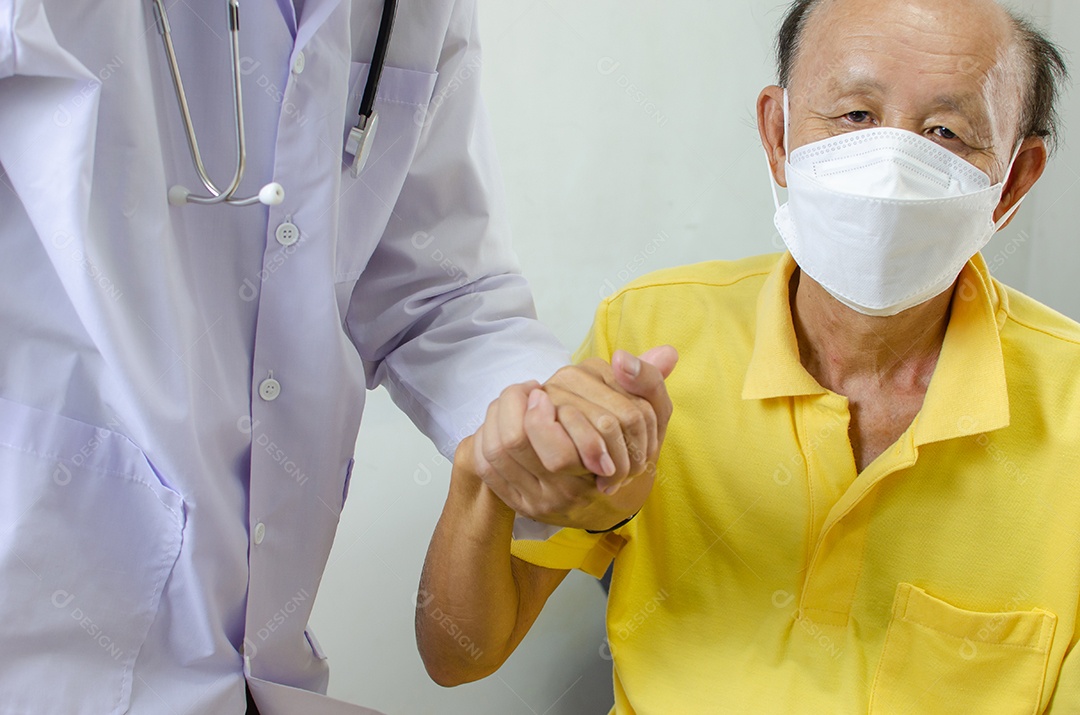 médico está segurando a mão de um homem idoso para animá-lo.