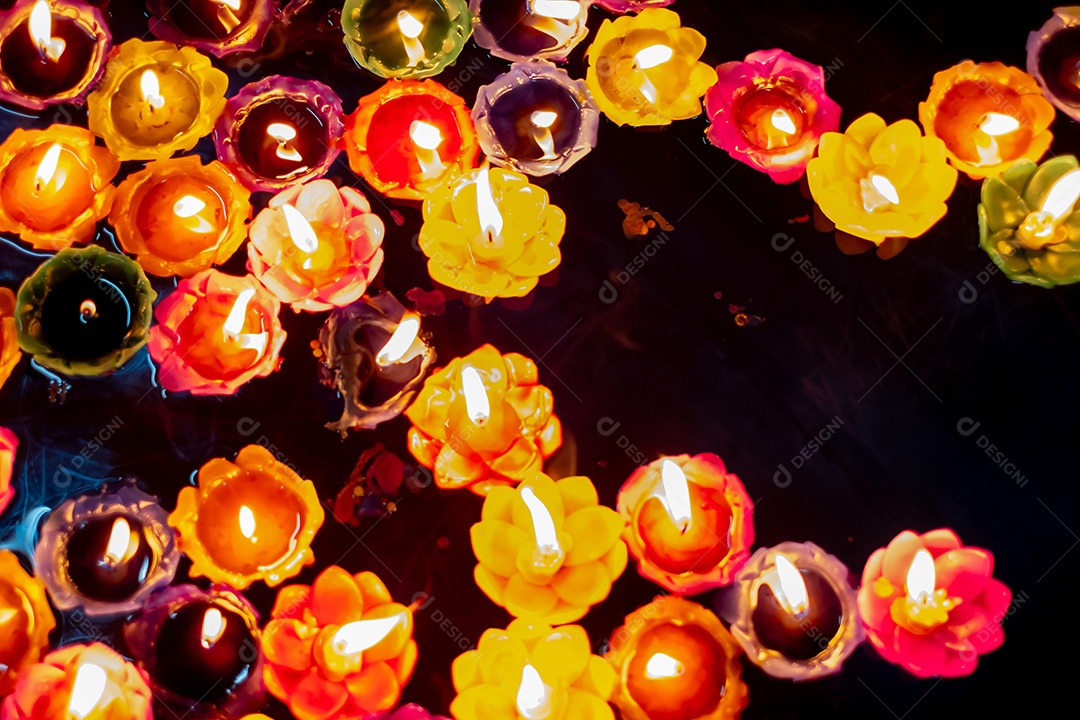 Acenda uma pequena vela multicolorida no templo para orar pelas bênçãos sagradas