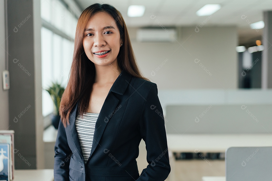 Retrato de funcionária asiática sorrindo para a câmera