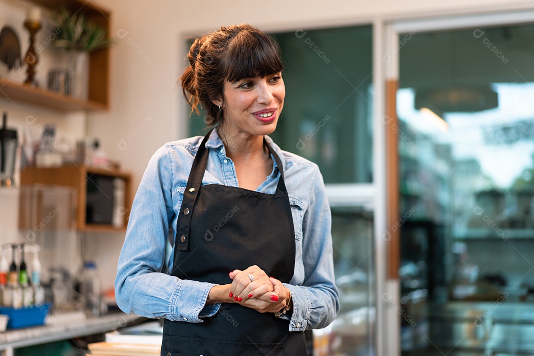 Retrato do dono de uma cafeteria feliz saudando o cliente