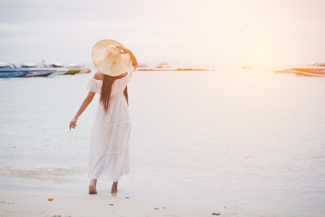 Mulher asiática na praia curtindo viagens e ar fresco nas férias. Conceito de férias e ao ar livre. Conceito de pessoas e natureza. Beleza asiática e tema do mar.