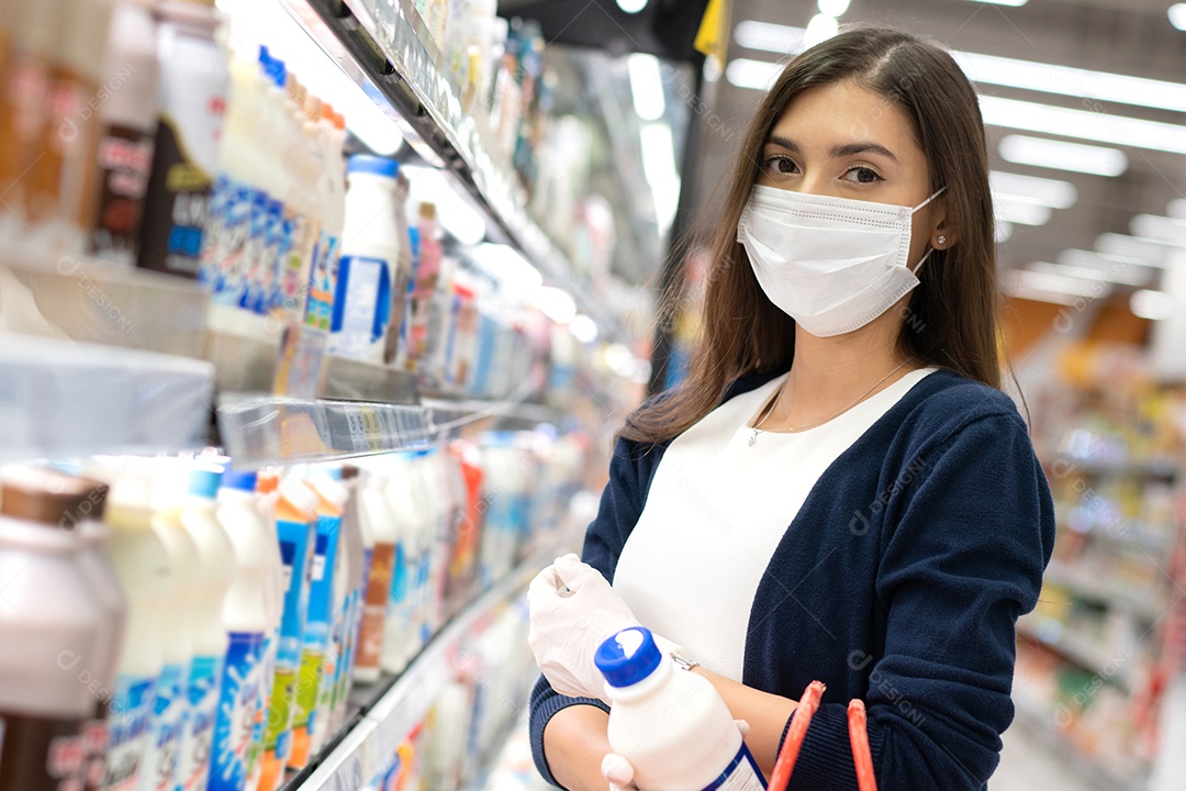 Mulher usando máscara médica e luva de borracha comprando leite diariamente